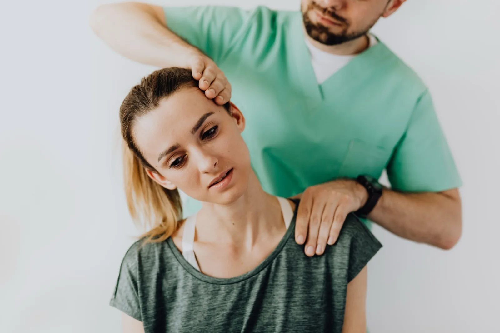 Person holding their neck, neck pain care at Cool Springs Chiropractic
