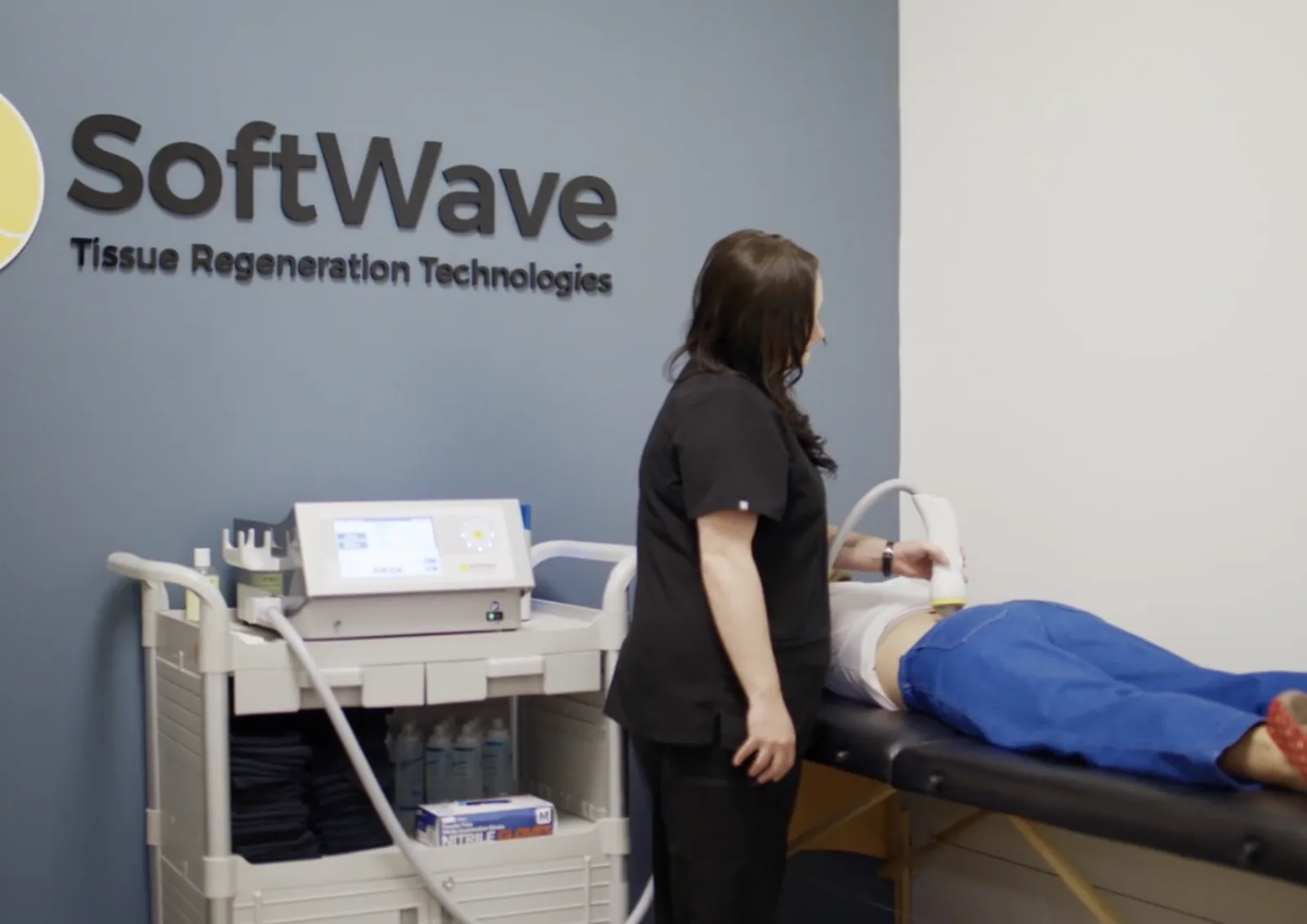 SoftWave therapy applicator delivering acoustic waves to a treatment area